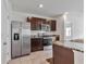 Kitchen featuring stainless steel appliances, dark cabinets, and granite countertops at 5121 Sultana Cv, Bradenton, FL 34211