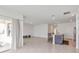 Open-concept living space with tile flooring, sliding glass doors, and a breakfast bar area at 5121 Sultana Cv, Bradenton, FL 34211