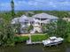 Breathtaking aerial view of a waterfront home with a private dock and beautiful pool and surrounded by greenery at 5132 Jungle Plum Rd, Sarasota, FL 34242