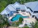 High angle home image boasting a uniquely shaped private pool, outdoor patio area and lush tropical landscaping at 5132 Jungle Plum Rd, Sarasota, FL 34242