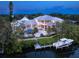 Waterfront home with private pool, dock, and manicured lawn overlooking a canal, offering serene outdoor living at 5132 Jungle Plum Rd, Sarasota, FL 34242