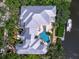 Aerial of property showing a pool, boat dock and gray roof at 5132 Jungle Plum Rd, Sarasota, FL 34242
