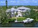 Expansive waterfront estate featuring a pool, lush landscaping, private dock, and boat for luxurious outdoor living at 5132 Jungle Plum Rd, Sarasota, FL 34242