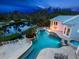 Aerial view of the property showcasing the pool, spa, landscaping, and waterfront location at 5132 Jungle Plum Rd, Sarasota, FL 34242