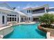 Beautiful backyard featuring a pool, spa, covered patio, and lush landscaping, creating a private oasis at 5132 Jungle Plum Rd, Sarasota, FL 34242