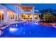 Lush backyard with a sparkling pool, cascading waterfall, spa and outdoor seating area for entertaining guests at 5132 Jungle Plum Rd, Sarasota, FL 34242