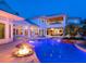 Stunning backyard featuring a pool, spa, fire pit, and covered patio, perfect for outdoor entertaining at 5132 Jungle Plum Rd, Sarasota, FL 34242