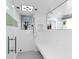 Bright, white bathroom with sleek glass shower, bench, and rainfall shower head at 5132 Jungle Plum Rd, Sarasota, FL 34242