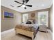 Comfortable bedroom with natural light, ceiling fan, and calming artwork for a restful retreat at 5132 Jungle Plum Rd, Sarasota, FL 34242