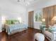 Bright bedroom with wood floors, a large window, and comfortable seating for a relaxing retreat at 5132 Jungle Plum Rd, Sarasota, FL 34242