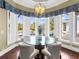 Bright breakfast nook with large windows offering views of the pool and manicured landscaping at 5132 Jungle Plum Rd, Sarasota, FL 34242
