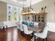 Formal dining room with wood floors, elegant lighting, and space for entertaining at 5132 Jungle Plum Rd, Sarasota, FL 34242
