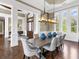Formal dining room with wood floors, elegant lighting, and space for entertaining at 5132 Jungle Plum Rd, Sarasota, FL 34242