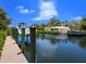Waterfront property featuring a private boat dock and spacious backyard, perfect for enjoying the coastal lifestyle at 5132 Jungle Plum Rd, Sarasota, FL 34242