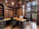 Executive home office with custom wood paneling, built-in shelving, and spiral staircase at 5132 Jungle Plum Rd, Sarasota, FL 34242