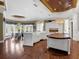 Expansive kitchen featuring custom islands, white cabinetry, stainless appliances, and open dining area at 5132 Jungle Plum Rd, Sarasota, FL 34242