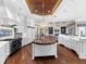 Gourmet kitchen featuring a large island, stainless steel appliances, and a seamless flow into the living area at 5132 Jungle Plum Rd, Sarasota, FL 34242