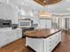 Spacious kitchen featuring a large island with butcher block countertop, custom cabinets, and modern appliances at 5132 Jungle Plum Rd, Sarasota, FL 34242