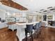 Gourmet kitchen featuring a large island, breakfast bar, hardwood floors, and adjacent living room at 5132 Jungle Plum Rd, Sarasota, FL 34242