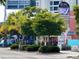 Lush trees line the sidewalk near a quaint shopping center featuring local businesses and restaurants at 5132 Jungle Plum Rd, Sarasota, FL 34242