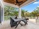 Covered outdoor dining area overlooking lush greenery and a waterway, perfect for al fresco dining at 5132 Jungle Plum Rd, Sarasota, FL 34242