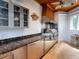 Outdoor kitchen with a granite countertop, stainless steel cabinets, and grill for outdoor gatherings at 5132 Jungle Plum Rd, Sarasota, FL 34242