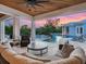 Luxurious covered patio with comfortable seating and a stunning view of the pool and landscaped backyard at 5132 Jungle Plum Rd, Sarasota, FL 34242