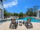 Inviting backyard pool area with comfortable lounge chairs, perfect for relaxation and enjoying the outdoors at 5132 Jungle Plum Rd, Sarasota, FL 34242