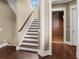 Elegant staircase complemented by rich wood floors and a convenient home elevator at 5132 Jungle Plum Rd, Sarasota, FL 34242