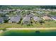 An aerial view of a well-maintained community with lake access and a screened-in pool at 5320 Tide Point Way, Bradenton, FL 34208