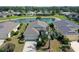 An eye-level view shows a beautiful home surrounded by meticulously manicured landscaping and serene pond views at 5320 Tide Point Way, Bradenton, FL 34208