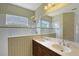 Bathroom with a double vanity, white tiled shower and patterned wallpaper at 5320 Tide Point Way, Bradenton, FL 34208