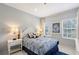 Comfortable bedroom featuring a queen-sized bed, neutral walls and two windows at 5320 Tide Point Way, Bradenton, FL 34208