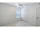 Well-lit bedroom with a ceiling fan, closet, and marble tile flooring at 5320 Tide Point Way, Bradenton, FL 34208