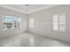 Bright bedroom with white brick walls, marble tile floors and natural light from two windows at 5320 Tide Point Way, Bradenton, FL 34208