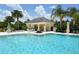 A community pool featuring covered seating and table area surrounded by palm trees at 5320 Tide Point Way, Bradenton, FL 34208