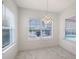 Bright dining room with tile floors, modern light fixture, and picturesque view of the pool and outdoor area at 5320 Tide Point Way, Bradenton, FL 34208