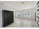Dining room with neutral paint, tile floors, black armoire, and abundant natural light from the view of the rear yard at 5320 Tide Point Way, Bradenton, FL 34208