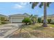 Charming home with well-manicured front yard, lush landscaping, and a spacious driveway leading to a two-car garage at 5320 Tide Point Way, Bradenton, FL 34208