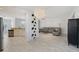Bright living room with marble floors, modern lighting fixture and comfortable seating at 5320 Tide Point Way, Bradenton, FL 34208