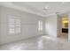 Spacious main bedroom featuring large windows, marble floors, and a ceiling fan at 5320 Tide Point Way, Bradenton, FL 34208