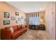 Office space featuring a wooden desk, comfortable orange sofa and decorative wall art at 5320 Tide Point Way, Bradenton, FL 34208