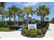 Community playground featuring a ' Corner' sign, playground equipment, and bordered with greenery and trees at 5320 Tide Point Way, Bradenton, FL 34208