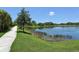 Scenic view of a community walking path alongside a tranquil pond, showcasing natural beauty at 5320 Tide Point Way, Bradenton, FL 34208