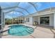 A screened-in pool with tanning ledge includes outdoor dining, a covered patio, and meticulously maintained landscaping at 5320 Tide Point Way, Bradenton, FL 34208