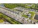 An aerial view shows the property in a neighborhood near a pond, pool, and clubhouse at 5985 Amberly Dr, Bradenton, FL 34208