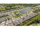 Aerial view of homes near a pond with a clubhouse and community pool at 5985 Amberly Dr, Bradenton, FL 34208