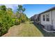 A spacious backyard showcases the property's screen porch and lush landscaping at 5985 Amberly Dr, Bradenton, FL 34208