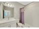 Bathroom with a white single sink vanity, shower, and tiled floors at 5985 Amberly Dr, Bradenton, FL 34208