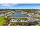 A resort-style community pool and clubhouse overlook a tranquil pond and lush landscaping at 5985 Amberly Dr, Bradenton, FL 34208